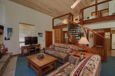 a living room with a couch and a table at 92R Jolie Cabin in North Wawona
