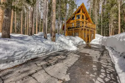 a log cabin in the woods in the snow at Soda Springs Surprise in Soda Springs