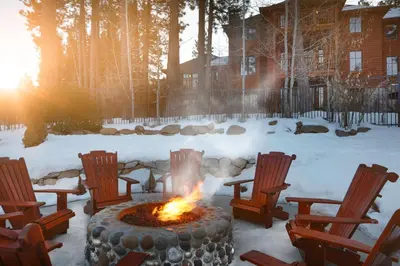 a fire pit with rocking chairs in the snow at Hyatt Vacation Club at High Sierra Lodge in Incline Village