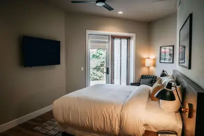 a bedroom with a bed and a tv and a window at Gateway Hotel, Trademark Collection by Wyndham in Copper Cove Subdivision