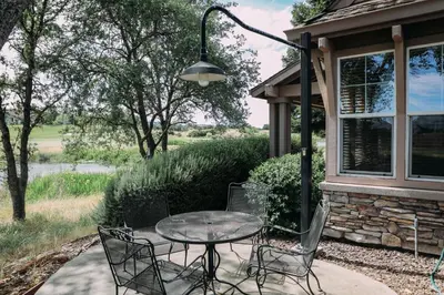 a patio with a table and chairs next to a house at Gateway Hotel, Trademark Collection by Wyndham in Copper Cove Subdivision