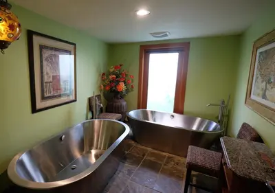 a large bathroom with a tub and a window at Yosemite Bug Rustic Mountain Resort in Midpines