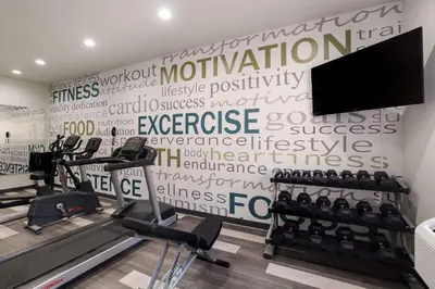 a gym with tread machines and a wall of words at Best Western Colfax in Colfax