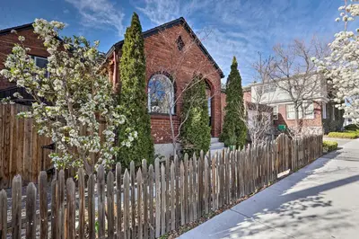 a wooden fence in front of a house at Ski, Shop and Explore Walkable Midtown Reno Oasis! in Reno