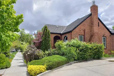 a red brick house with a garden in front of it at Ski, Shop and Explore Walkable Midtown Reno Oasis! in Reno