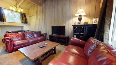 a living room with leather couches and a coffee table at Mammoth Estates 3 Bdrm Condos - Walking Distance to The Village Gondola Station in Mammoth Lakes