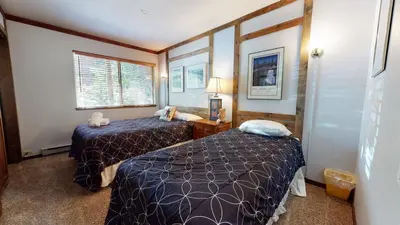 a small room with two beds and a window at 2 Bedroom Condos at Mammoth Estates - Near Mammoth Village! in Mammoth Lakes