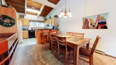 a kitchen with a wooden table and chairs at 2 Bedroom Condos at Mammoth Estates - Near Mammoth Village! in Mammoth Lakes