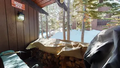 a covered porch of a cabin with snow on it at 2 Bedroom Condos at Mammoth Estates - Near Mammoth Village! in Mammoth Lakes