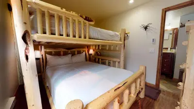a bedroom with two bunk beds and a mirror at Mammoth Estates Deluxe 2 Bedroom Condos in Mammoth Lakes