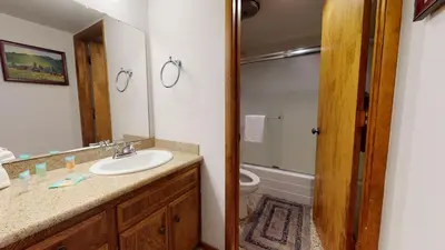 a bathroom with a sink and a toilet and a mirror at Mammoth Estates Deluxe 2 Bedroom Condos in Mammoth Lakes
