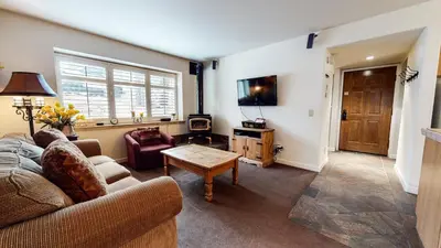 a living room with a couch and a table at Mammoth Estates Studio Condos 2 Blocks from The Village Gondola Station in Mammoth Lakes