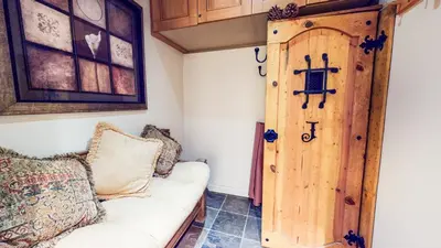 a living room with a couch and a wooden door at Mammoth Estates Studio Condos 2 Blocks from The Village Gondola Station in Mammoth Lakes