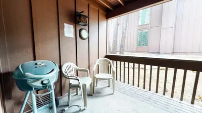 a balcony with two chairs and a table and a window at Mammoth Estates Studio Condos 2 Blocks from The Village Gondola Station in Mammoth Lakes
