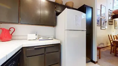 a kitchen with a white refrigerator in a room at Mammoth Estates 4 Bedroom Condos - Great for Families! in Mammoth Lakes