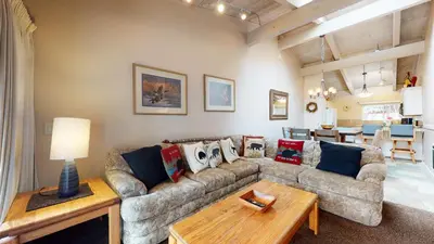a living room with a couch and a table at Mammoth Estates 4 Bedroom Condos - Great for Families! in Mammoth Lakes