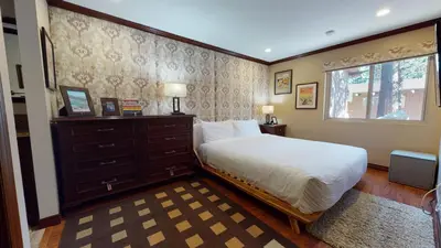 a bedroom with a bed and a dresser and a window at Mammoth Estates 4 Bedroom Condos - Great for Families! in Mammoth Lakes