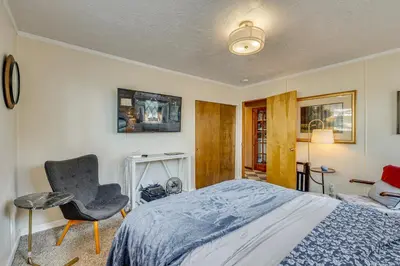 a bedroom with a bed and a chair at Balcony and Forest Views Cabin in Pioneer! in Pioneer