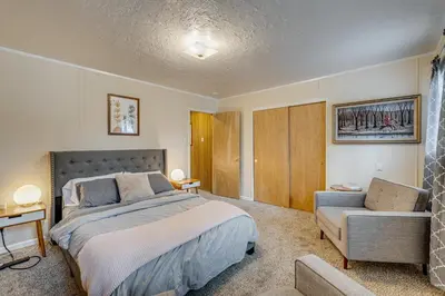 a bedroom with a bed and a couch at Balcony and Forest Views Cabin in Pioneer! in Pioneer