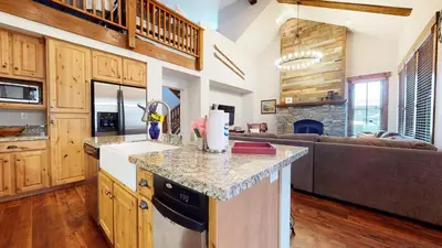 a kitchen with a counter top and a living room at Snowcreek The Lodges #1127 condo in Mammoth Lakes