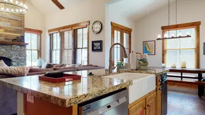 a kitchen with a counter top and a living room at Snowcreek The Lodges #1127 condo in Mammoth Lakes