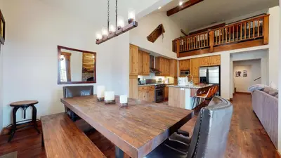 a kitchen and dining room with a wooden table at Snowcreek The Lodges #1127 condo in Mammoth Lakes