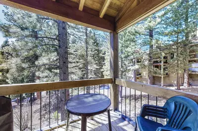 a screened in porch with two chairs and a table at Northstar Gold Bend Retreat in Truckee