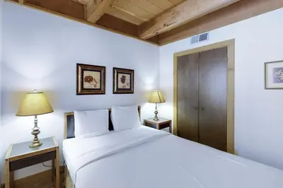 a bedroom with a white bed and two lamps at Northstar Gold Bend Retreat in Truckee