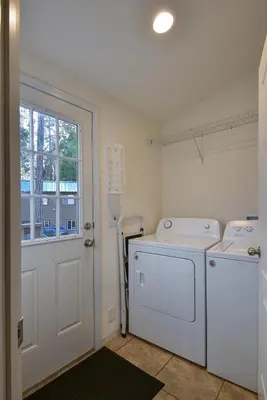a laundry room with a washer and dryer and a window at 3R Suter's Forte in North Wawona
