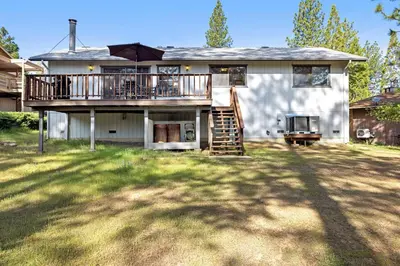 a house with a deck with an umbrella at Mountain Springs Lodge in Groveland