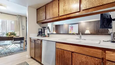 a kitchen with wooden cabinets and a sink at Horizons 4 #189 condo in Mammoth Lakes