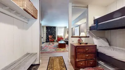 a bedroom with a bunk bed and a wooden dresser at Horizons 4 #189 condo in Mammoth Lakes