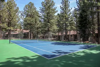 a tennis court with trees in the background at Horizons 4 #189 condo in Mammoth Lakes