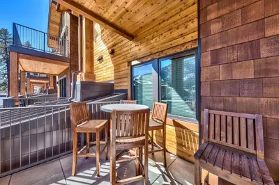 a porch with chairs and a table on a house at Luxury Three Bedroom Residence steps from Heavenly Village condo in South Lake Tahoe