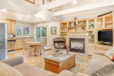 a living room with a fireplace and a table at Echo Escape in South Lake Tahoe