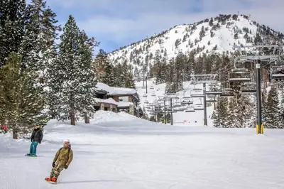 two people standing in the snow on a ski slope at Snowcreek 607 in Mammoth Lakes