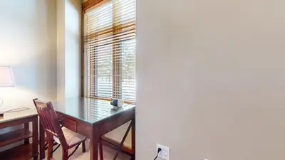 a dining room with a desk and a window at Solstice #18 condo in Mammoth Lakes