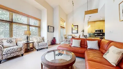 a living room with a couch and a table at Solstice #18 condo in Mammoth Lakes
