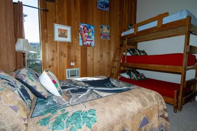 a bedroom with two bunk beds and a window at Mammoth Ski Racquet Club 55 in Mammoth Lakes