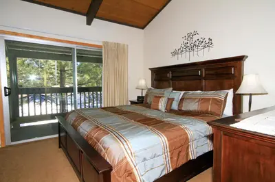 a bedroom with a bed and a large window at Sierra Park Villas 29 in Mammoth Lakes