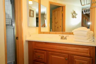 a bathroom with a sink and a mirror and towels at Sierra Park Villas 29 in Mammoth Lakes