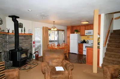 a living room with a chair and a stove at Sierra Park Villas 29 in Mammoth Lakes