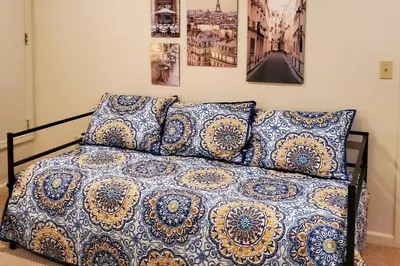 a bed with blue and white sheets and pillows at Gateway to Yosemite Group-Friendly Groveland Home in Groveland