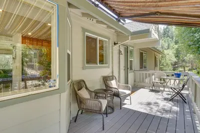 a porch with chairs and a table on it at Gateway to Yosemite Group-Friendly Groveland Home in Groveland