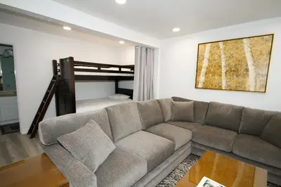 a living room with a couch and a bunk bed at Mammoth Ski Racquet Club 127 in Mammoth Lakes