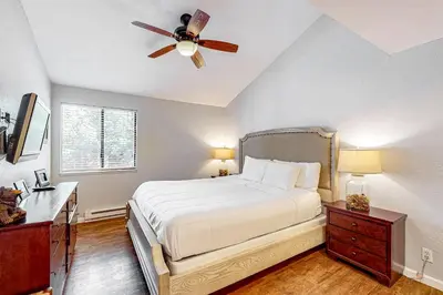 a bedroom with a bed and a ceiling fan at Summit 80 in Mammoth Lakes