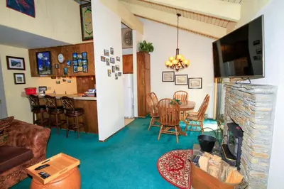 a living room with a couch and a living room with a fireplace at Discovery 4 150 Loft in Mammoth Lakes