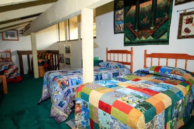 a bedroom with two beds with a colorful quilt at Discovery 4 150 Loft in Mammoth Lakes