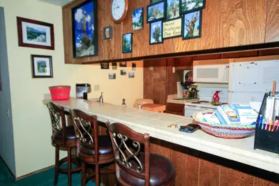 a kitchen with a counter with bar stools at Discovery 4 150 Loft in Mammoth Lakes
