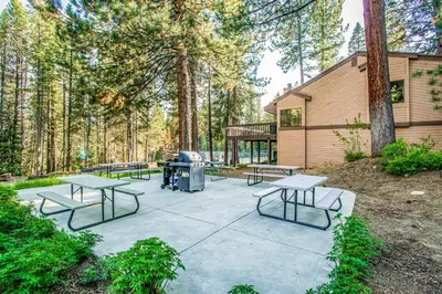 a picnic area with picnic tables and a grill at Lake Therapy in Lakeshore